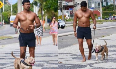 Sem camisa, Xamã passeia com cachorro pela orla da Barra Da Tijuca