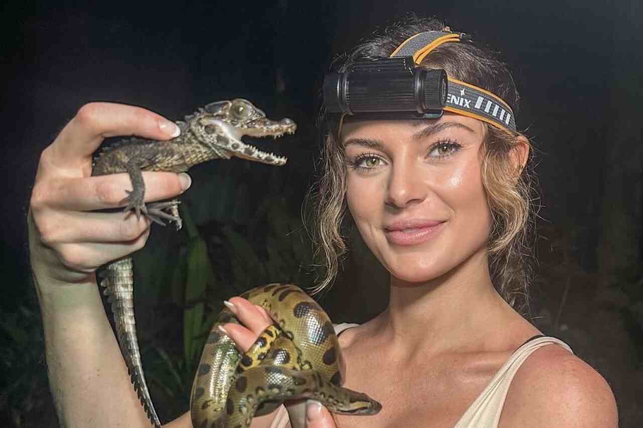 The "most beautiful scientist in the world" nearly shows too much after posing with a venomous snake