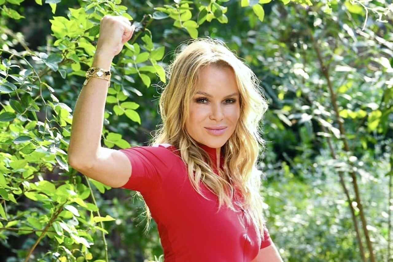 Amanda Holden poses on a bicycle and shows off her impeccable physique